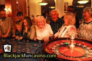A group having lots of fun at the roulette table